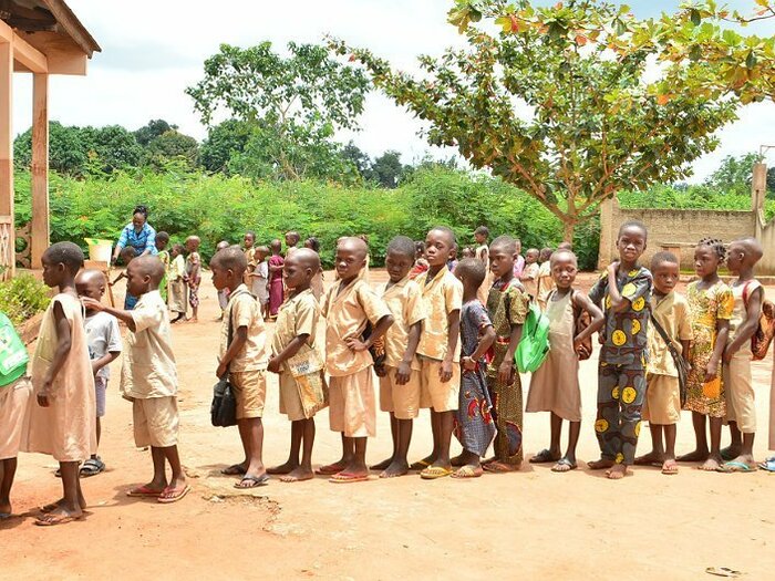 School children waiting in line to receive school meals sponsored by the national government and implemented by WFP